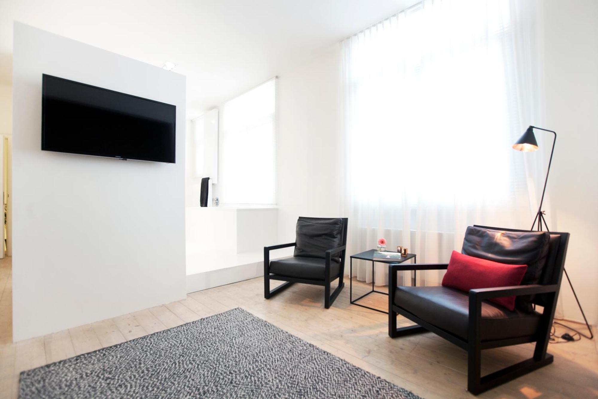 Maison Nationale City Flats & Suites Anversa Camera foto A room at the hotel