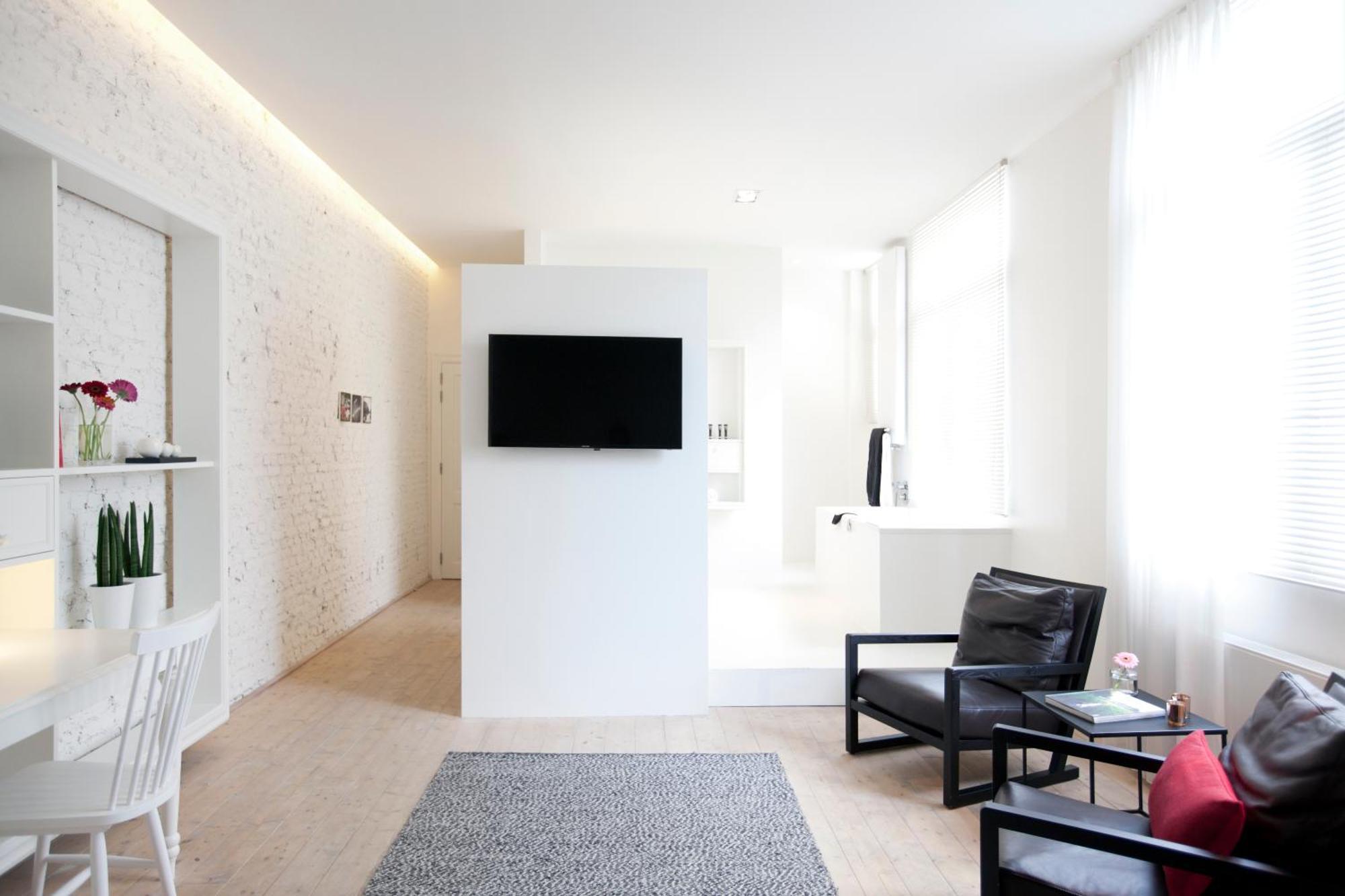 Maison Nationale City Flats & Suites Anversa Camera foto A room at the hotel